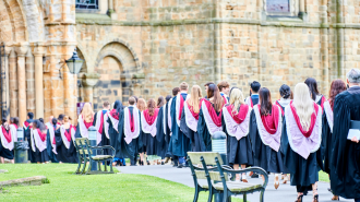 Tstudents in robes walking into the Cathedral during congregation