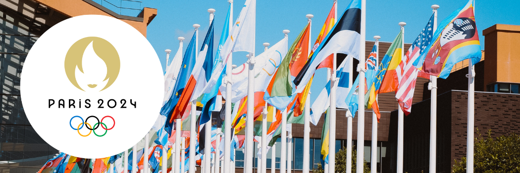 Lots of flags from around the world with teh Paris 2024 logo at the right hand side