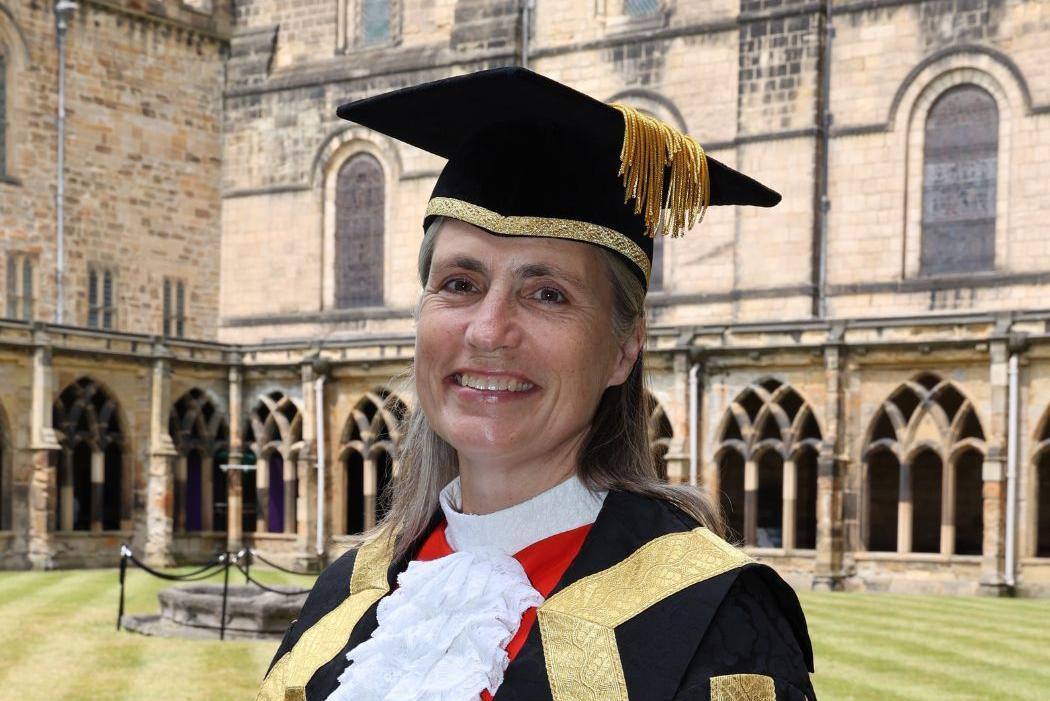 Dr Fiona Hill in academic dress at Durham Cathedral