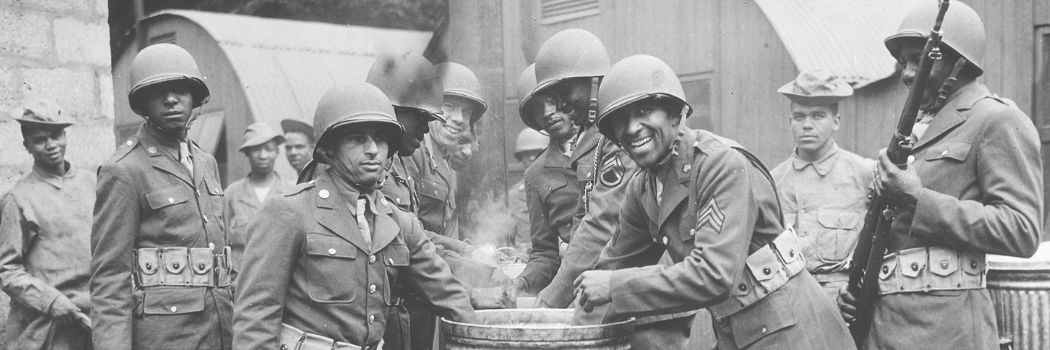 Black USA soldiers draw rations at the camp cook house at their station in Northern Ireland during World War Two