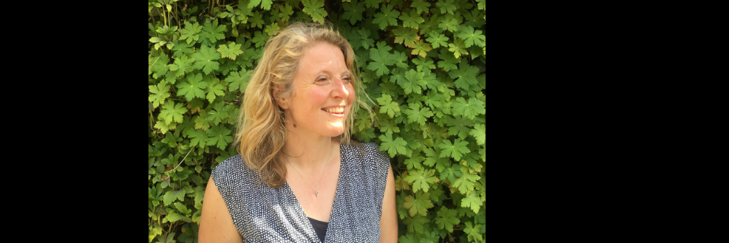 Professor Harriet Bulkeley in front of trees, looking off-camera