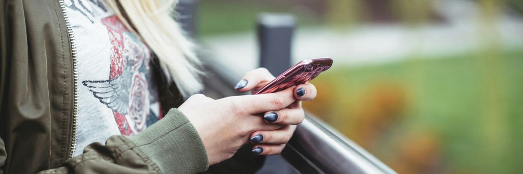 Close up of a woman's hand operating a mobile phone