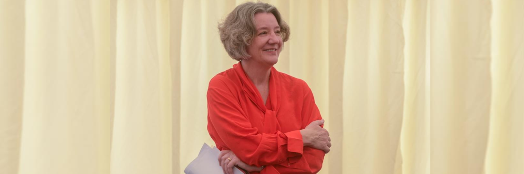 Vice Chancellor Karen O'Brien smiling with her arms folded wearing a red blouse