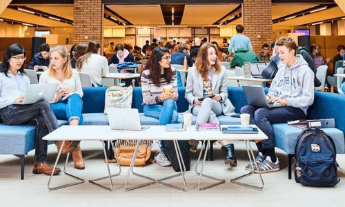 A group of students sat chatting at a table