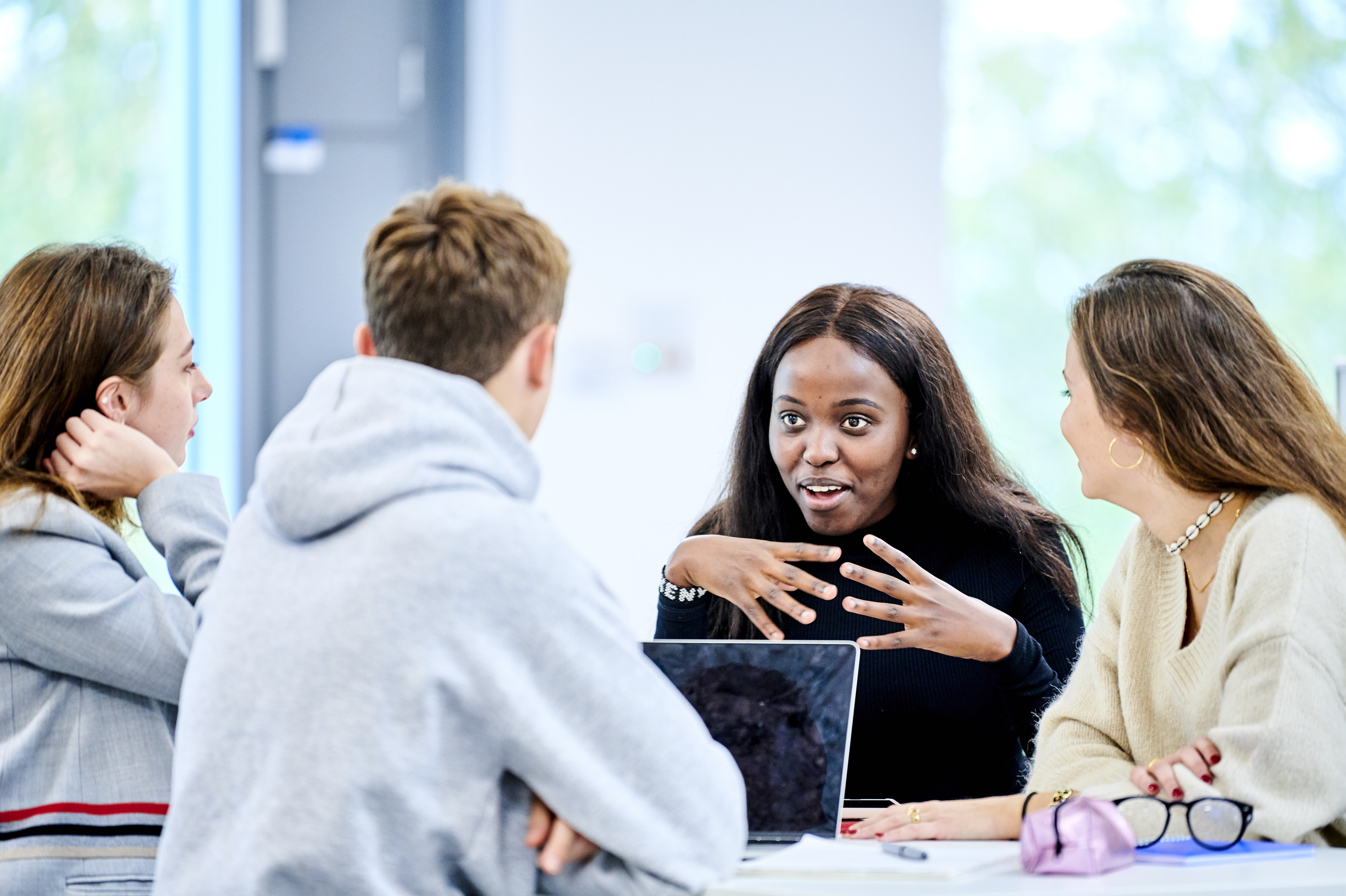 Four students sitting together having a discussion