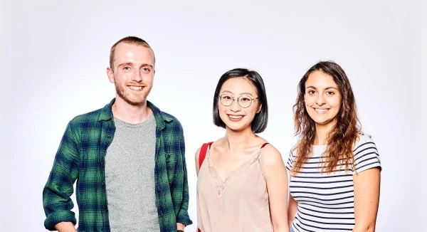 Three students smiling and posing