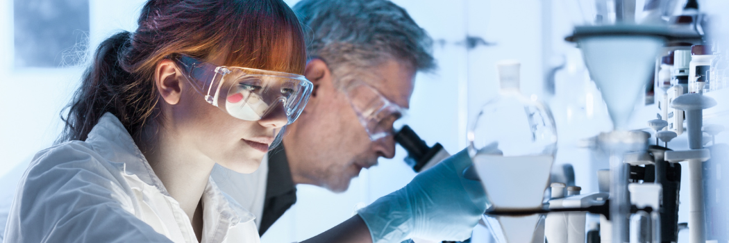 A man and a woman working in a laboratory setting