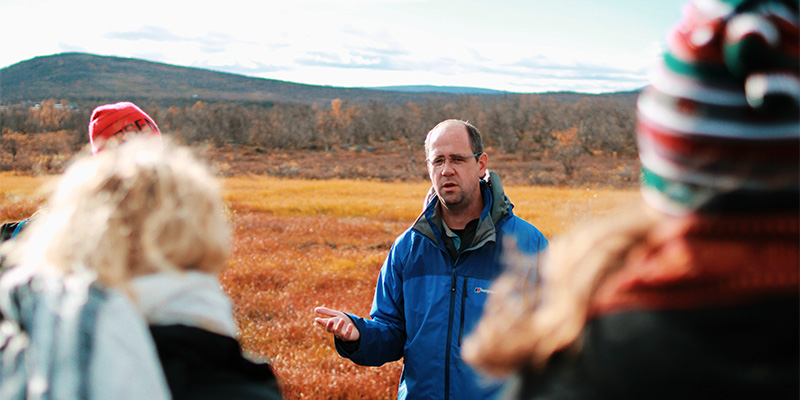 Man in conversation with group