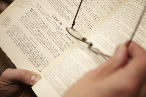 A law book held open with a pair of glasses resting on it