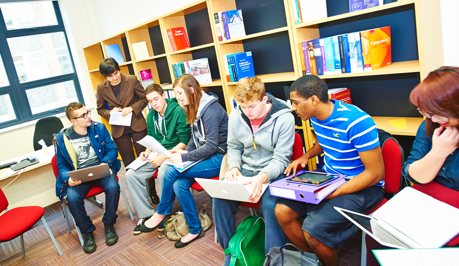 TA busy tutorial with students sitting in a semi-circle