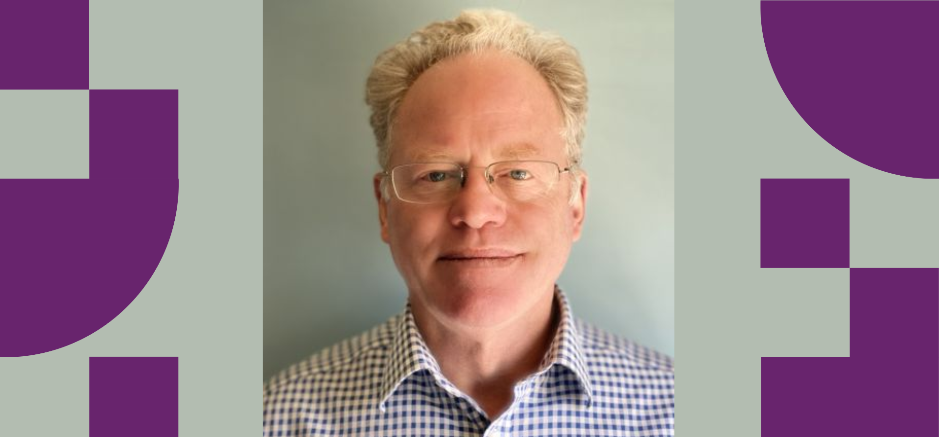 A smiling man with glasses and blond hair