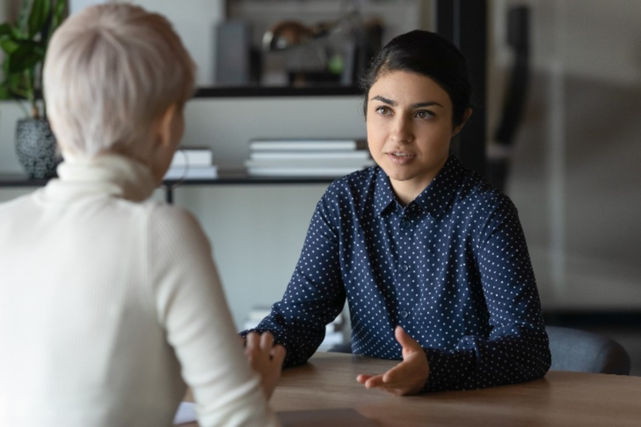 student talking to a counsellor at a table