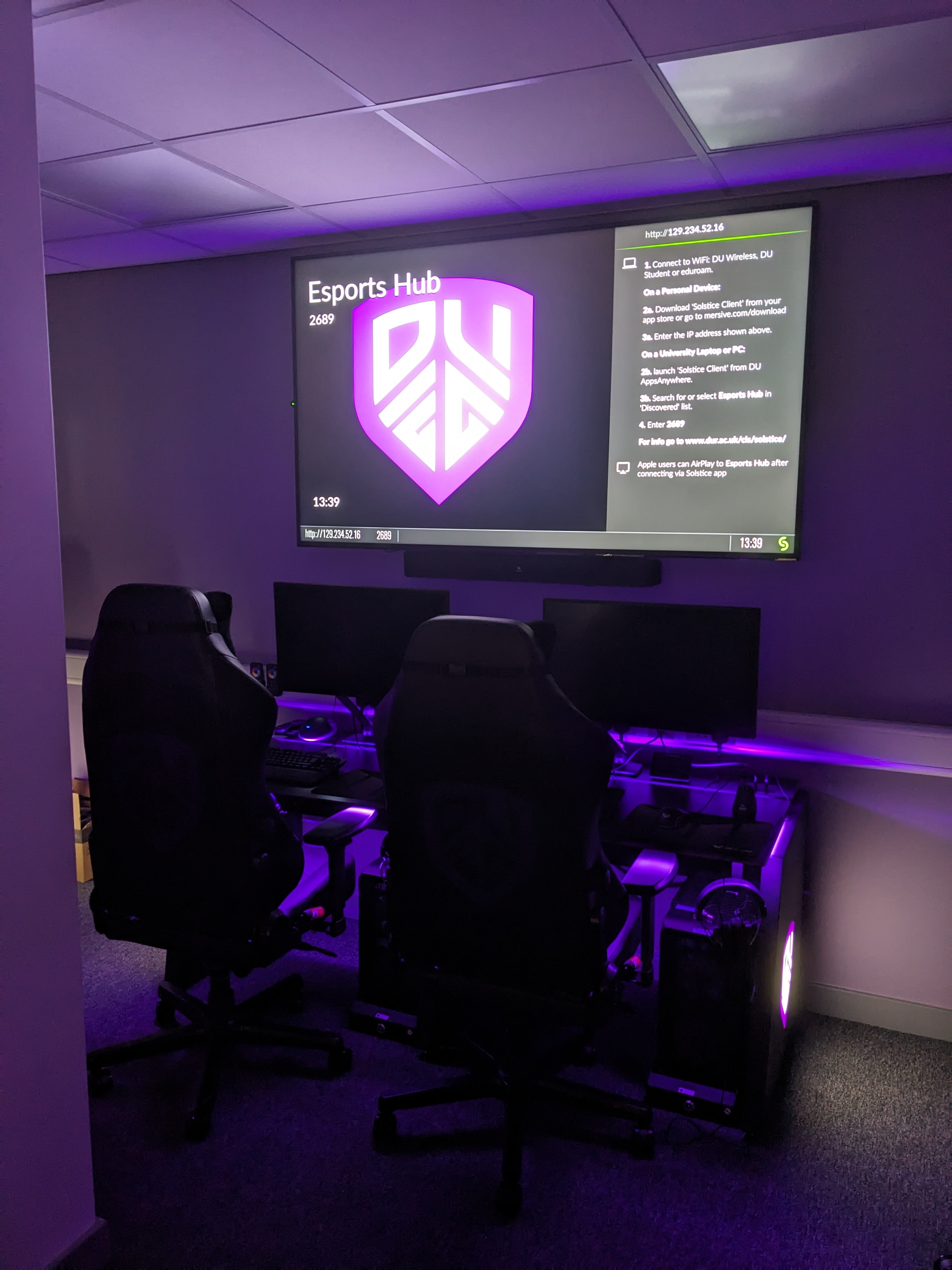 Front desks in the dark, lit up by purple